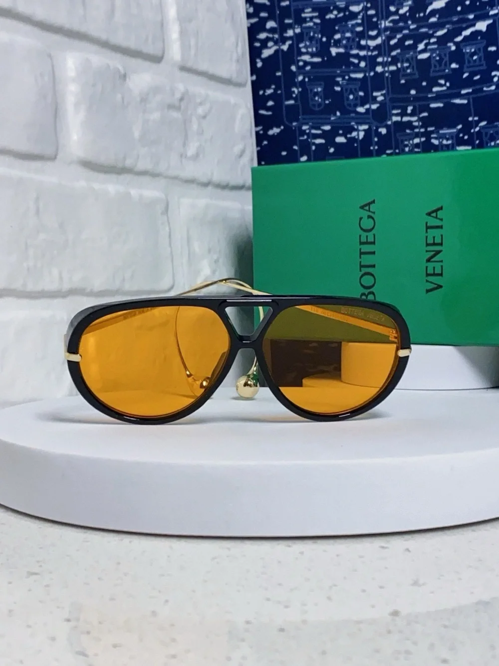 Bottega Veneta Black Frame Sunglasses with Amber Lenses and Gold Temples